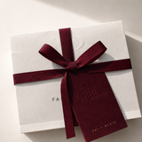 White gift box with a red ribbon and 'Fairyland' branding on a light background