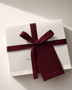 White gift box with a red ribbon and 'Fairyland' branding on a light background